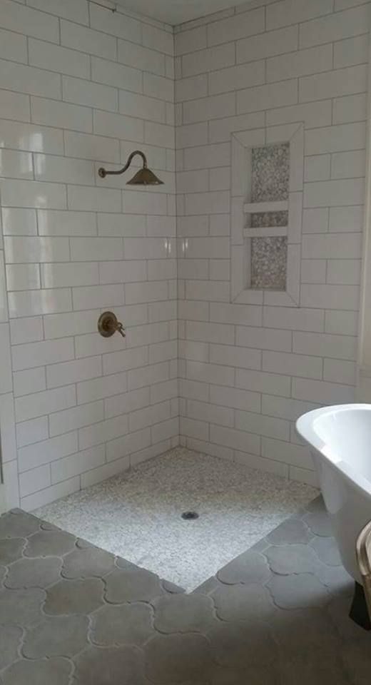 A bathroom with a walk in shower and a bathtub.