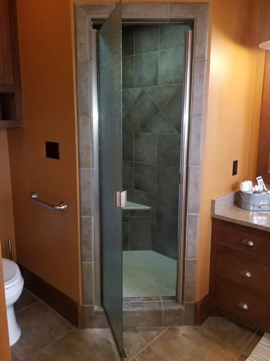 A bathroom with a walk in shower and a toilet.