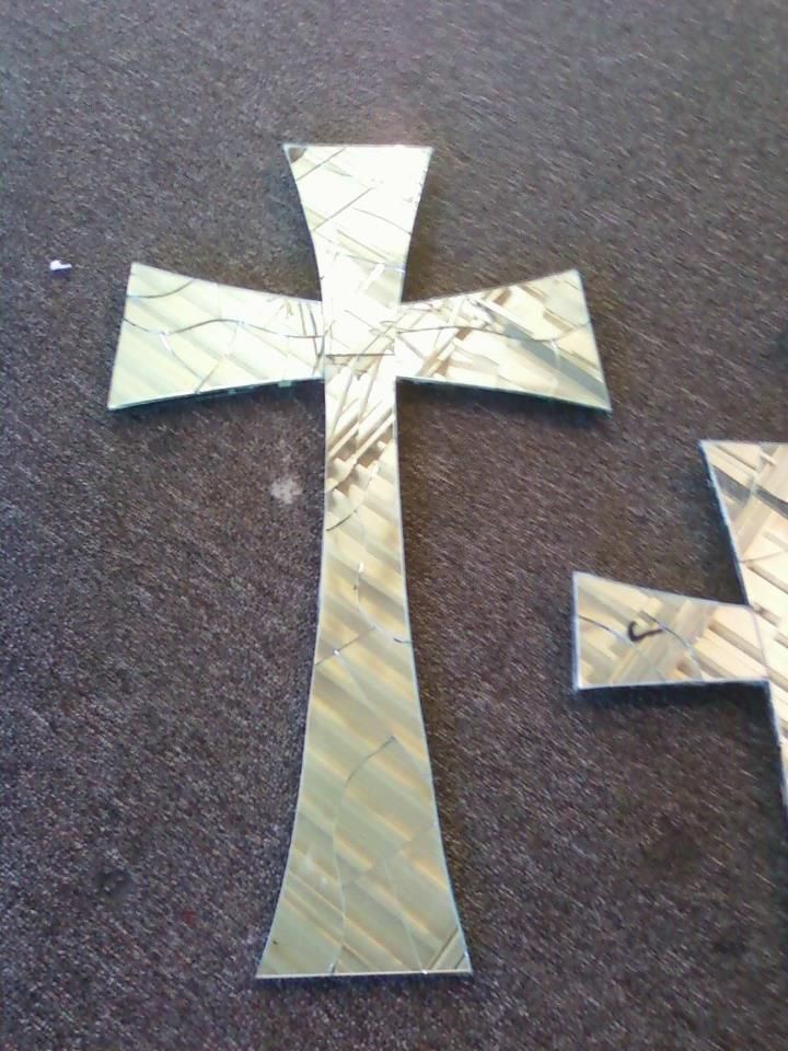 Two mirrored crosses are sitting on a carpet