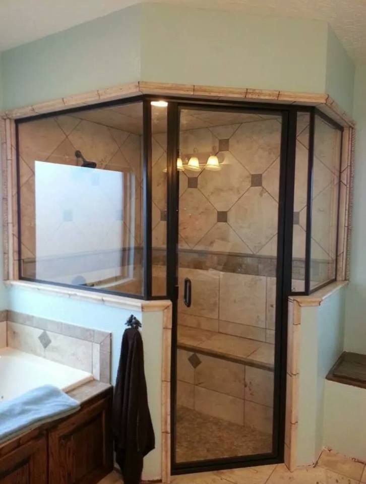 A bathroom with two sinks and a walk in shower.