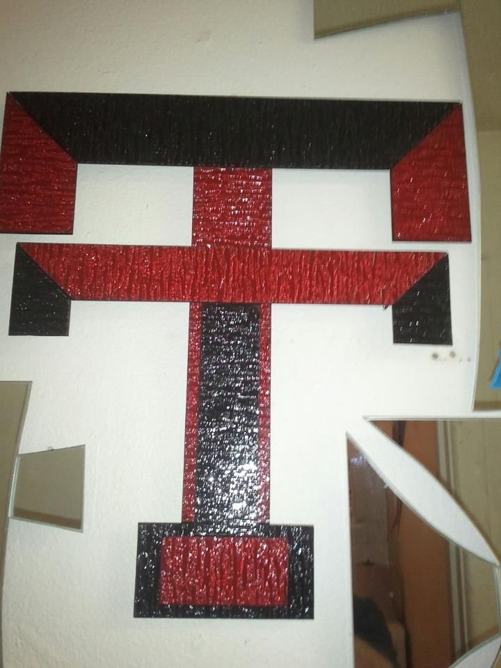 A red and black letter t on a white background