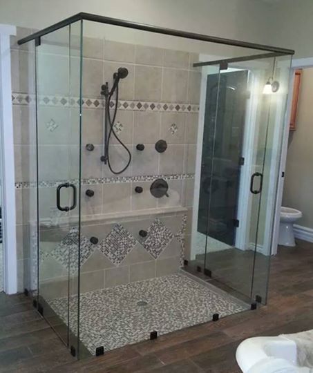 A bathroom with a walk in shower and a bathtub.