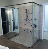 A bathroom with a walk in shower and a bathtub.
