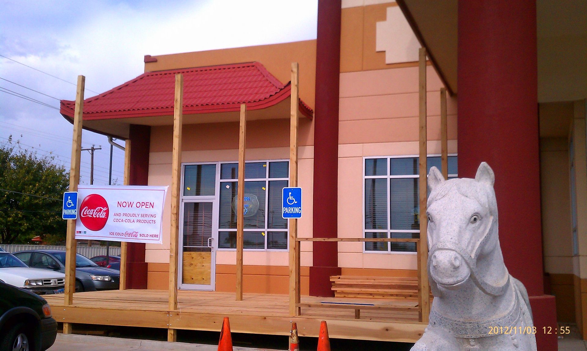 A statue of a horse is in front of a building