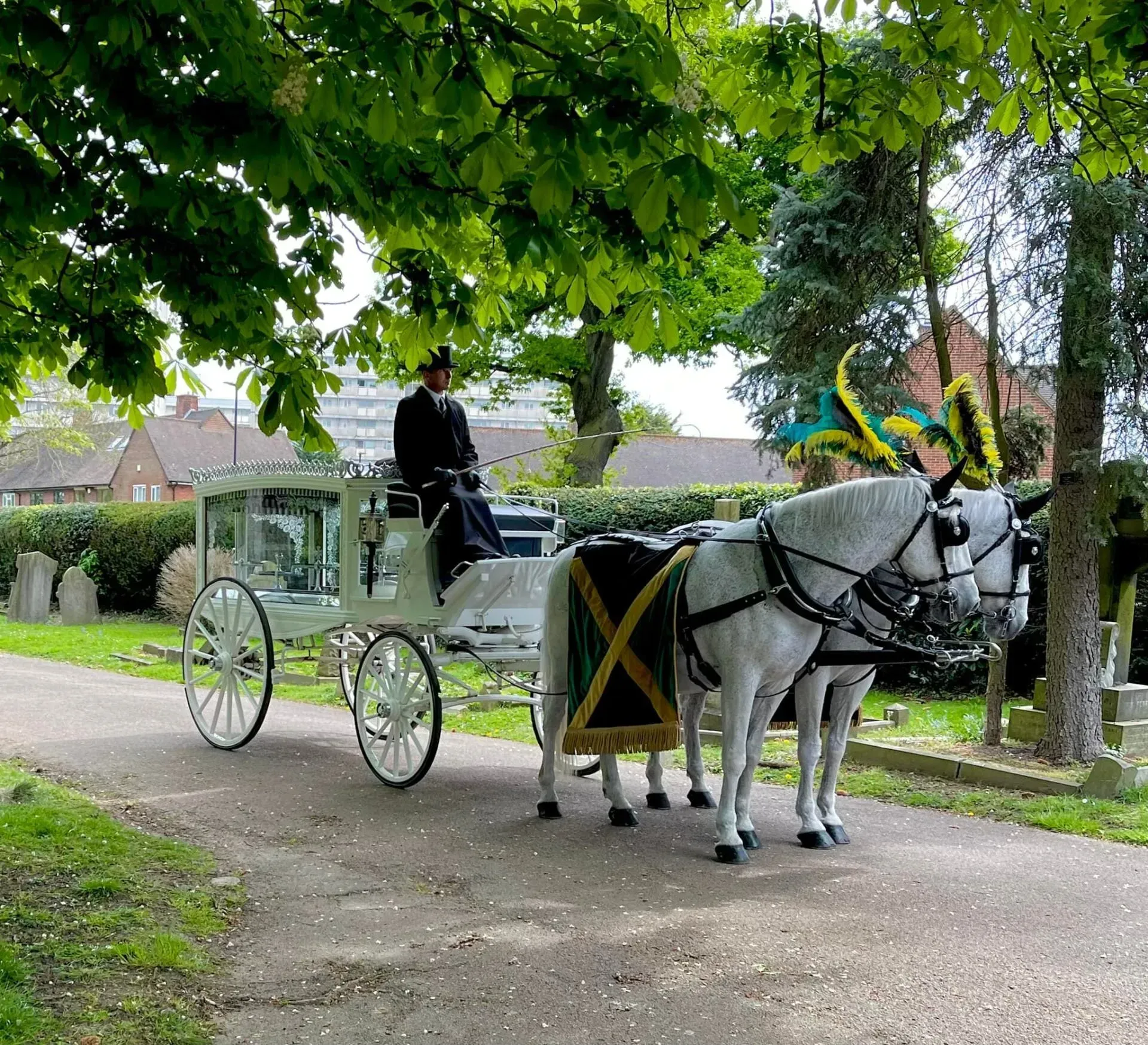 A horse drawn carriage with a man in the driver 's seat