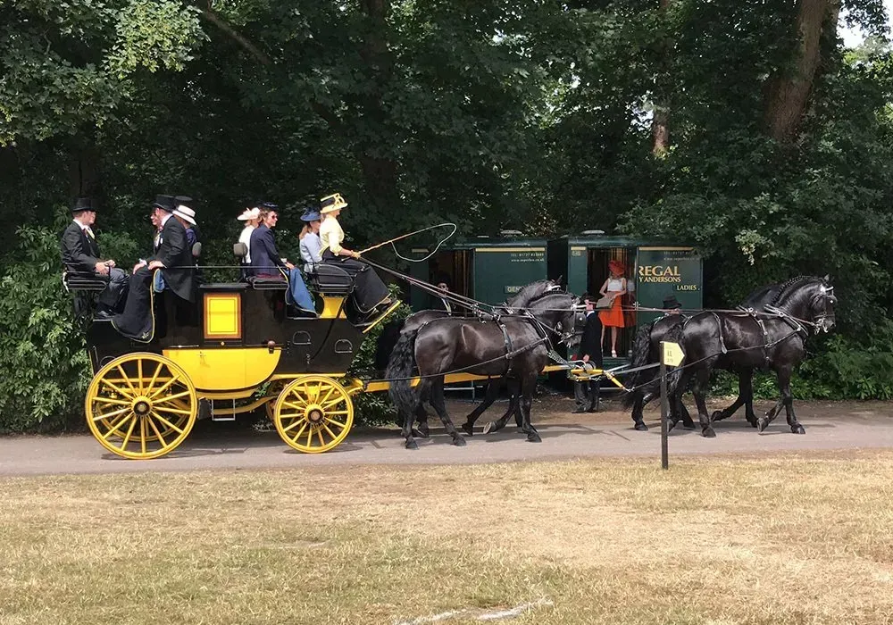 A horse drawn carriage with a sign that says ' rex ' on it