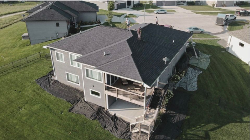 An aerial view of a house under construction in a residential area.