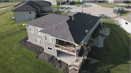 An aerial view of a house surrounded by trees.