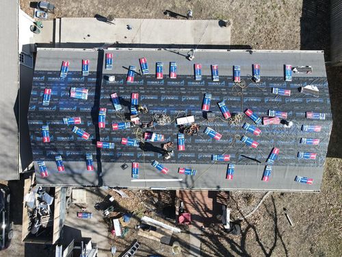 An aerial view of a roof being installed on a house.