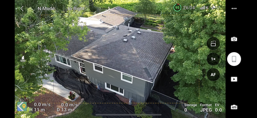 An aerial view of a house surrounded by trees.