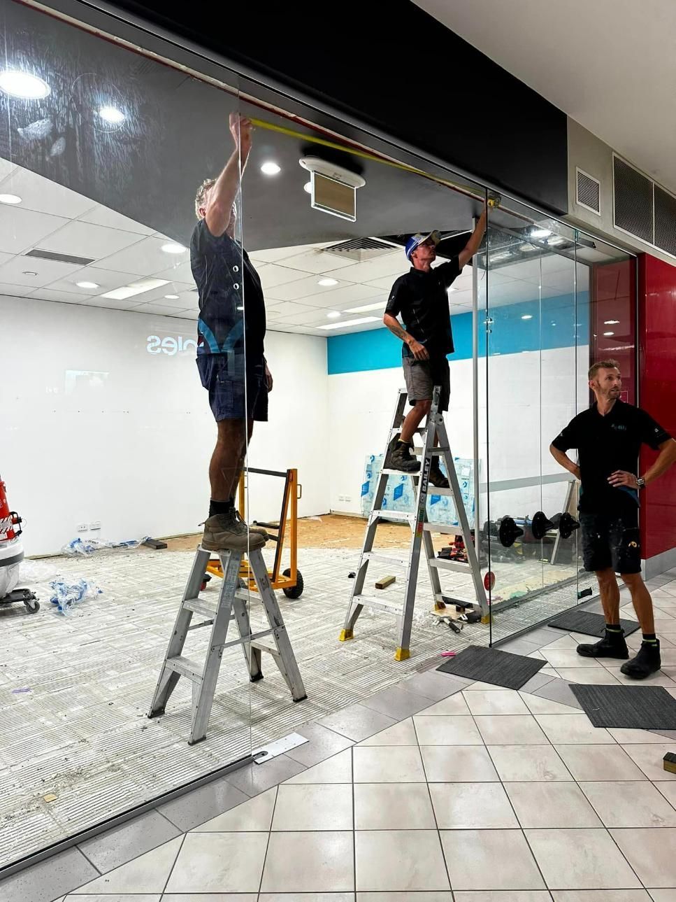 SC Glass Team Measure The Size Of The Glass Door — SC Glass & Aluminium in Yandina, QLD