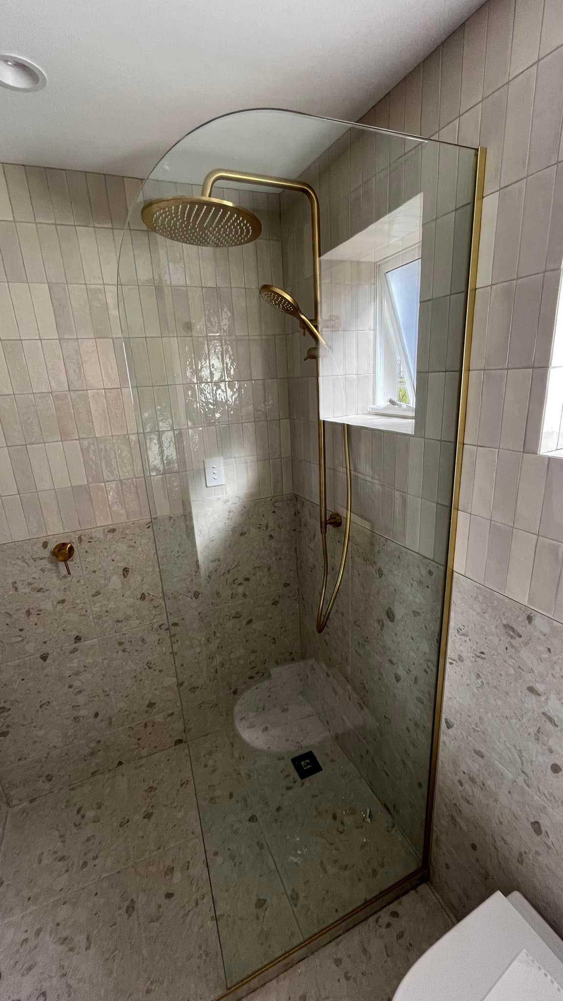 Gold Shower Head And Glass Door Of A Bathroom — SC Glass & Aluminium in Yandina, QLD