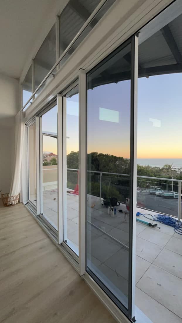 Glass Sliding Doors In A Room — SC Glass & Aluminium in Yandina, QLD