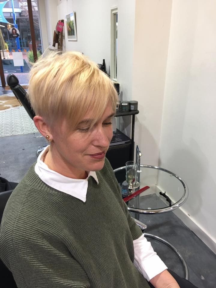 A Woman With Short Blonde Hair Is Sitting In A Chair In A Salon — Minnie & Lucille Hairdressing In Armidale, NSW