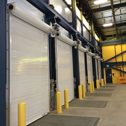 Several large industrial doors photographed from the inside of a facility.
