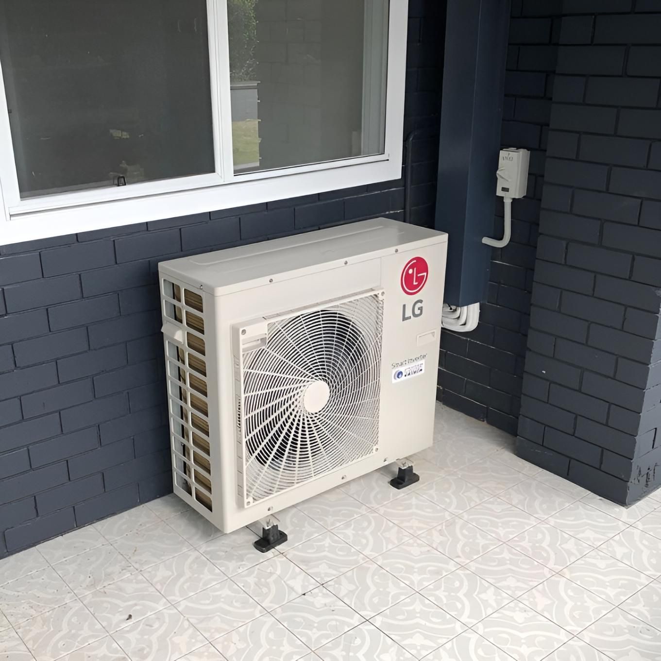 An Lg Air Conditioner is Sitting Outside — Atmosphere Air Conditioning & Refrigeration In Taylors Beach, NSW