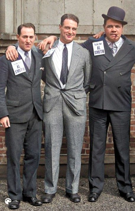 Three men are posing for a picture and one has a name tag that says k. smith