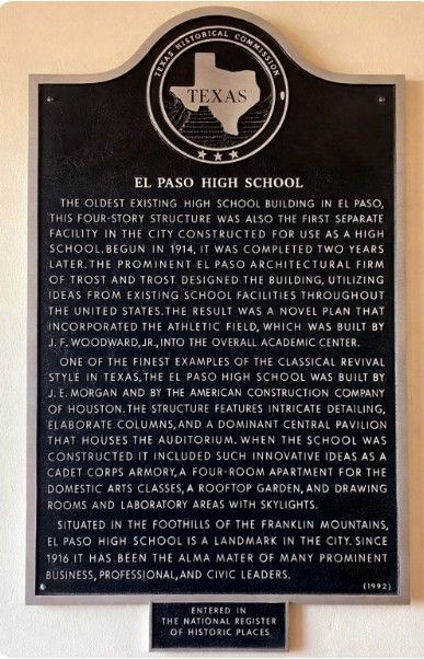 A man is carrying a woman on his shoulders in a black and white photo.