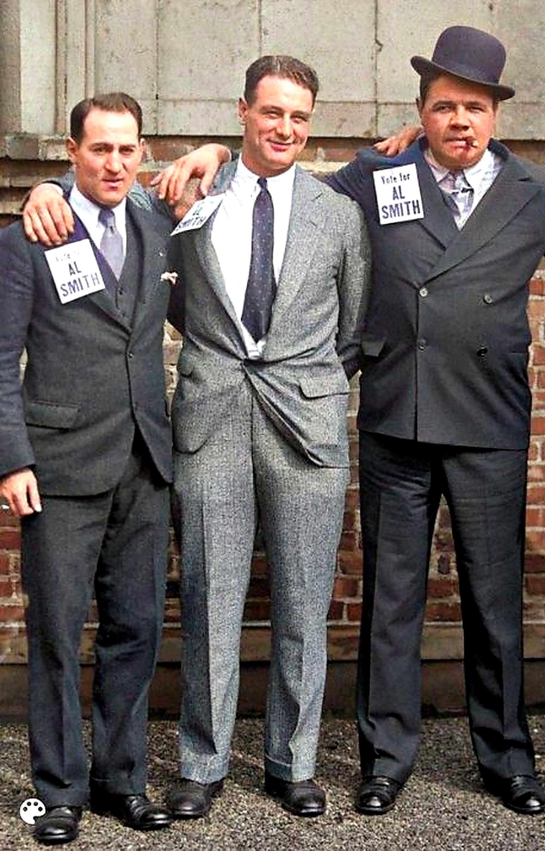 Three men are posing for a picture and one has a name tag that says k. smith