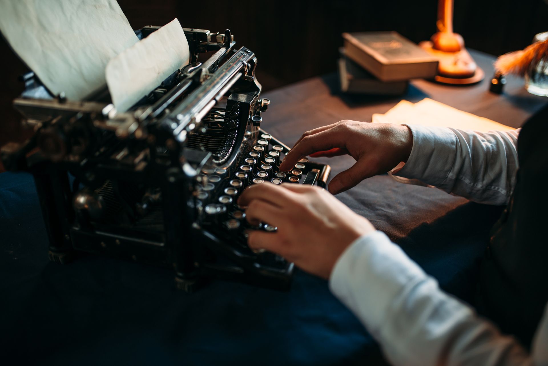 A person is typing on an old typewriter.