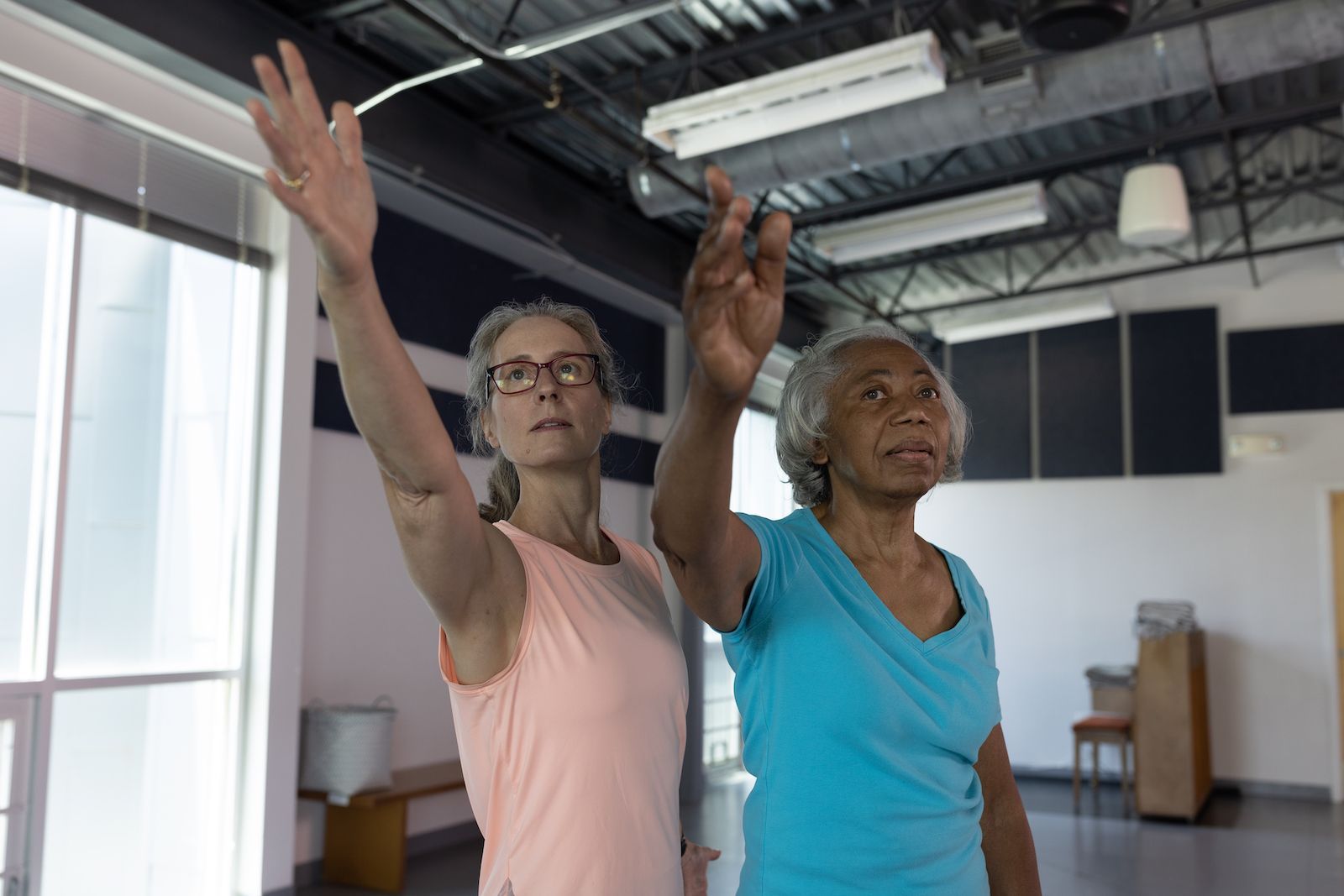 Two women are standing next to each other in a room.