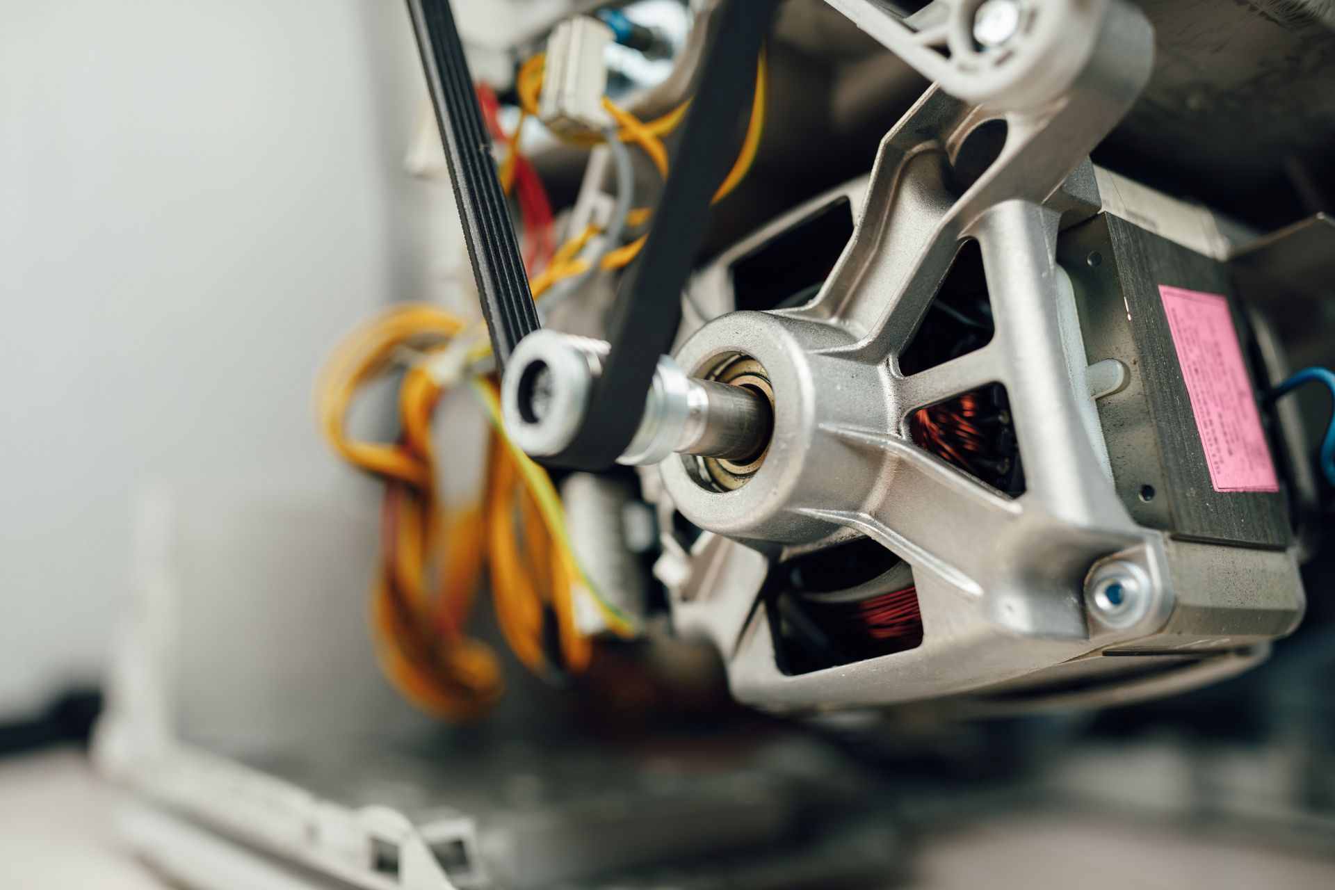 An engine of a washing machine with a belt roller.