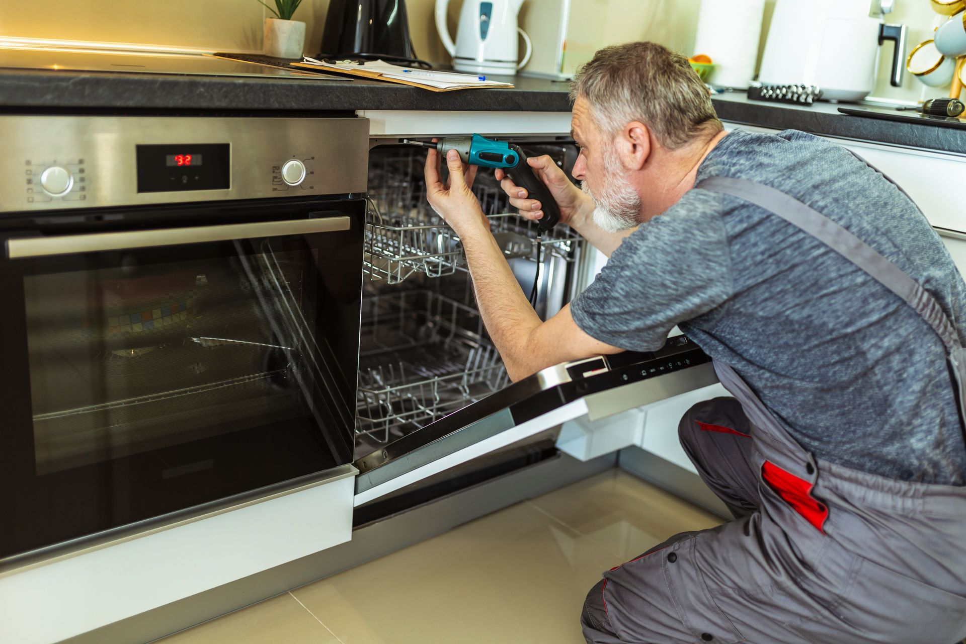 Appliance repair expert fixing a dishwasher.