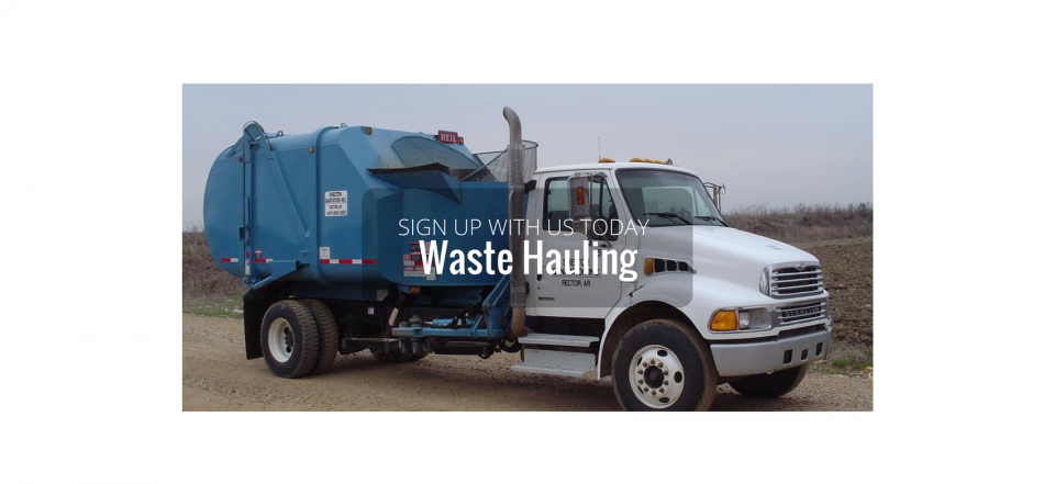 Blue waste hauling truck parked on a road with large white lettering on the side