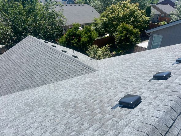 Worker Fixing Roof Tile — Roof Maintenance in Eugene, OR