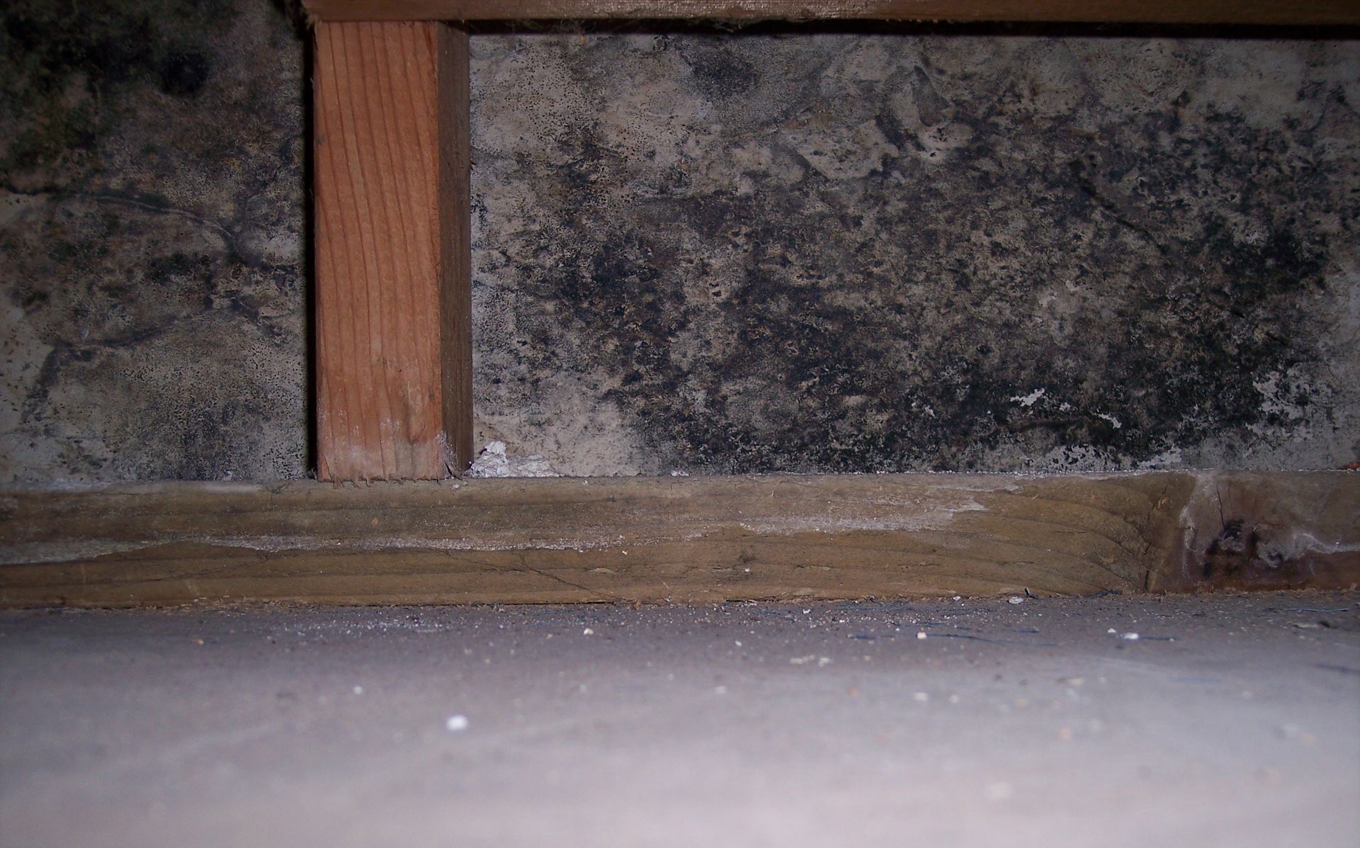 A close up of a concrete wall with a wooden frame.