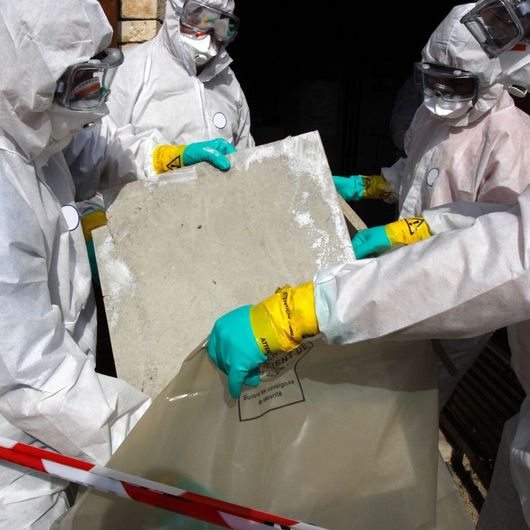 A group of people wearing protective suits and gloves