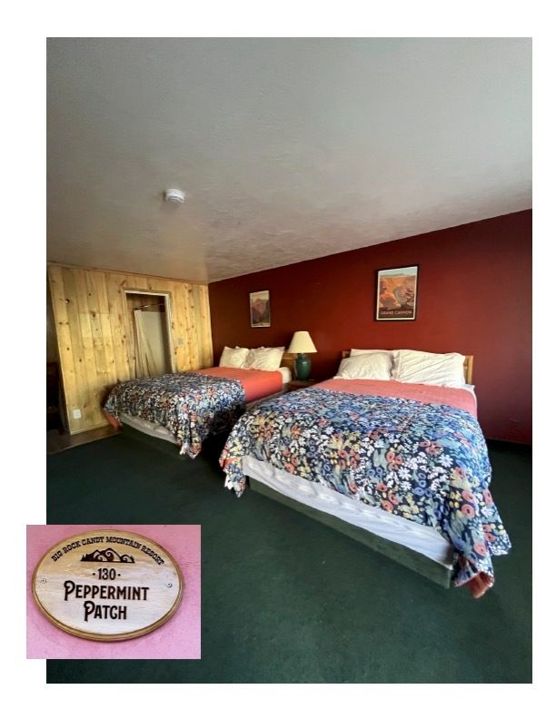 A hotel room with two beds and a sign that says peppermint patch.