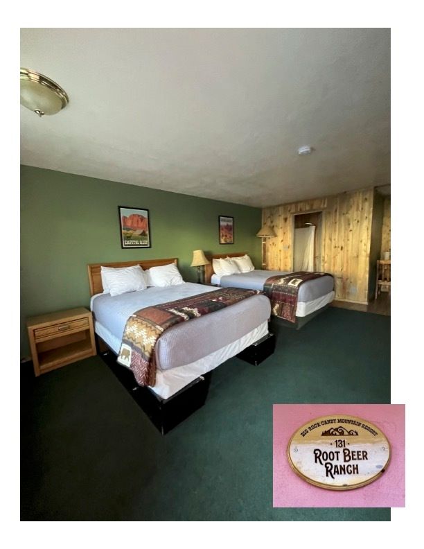 A hotel room with two beds and a sign that says root beer brunch