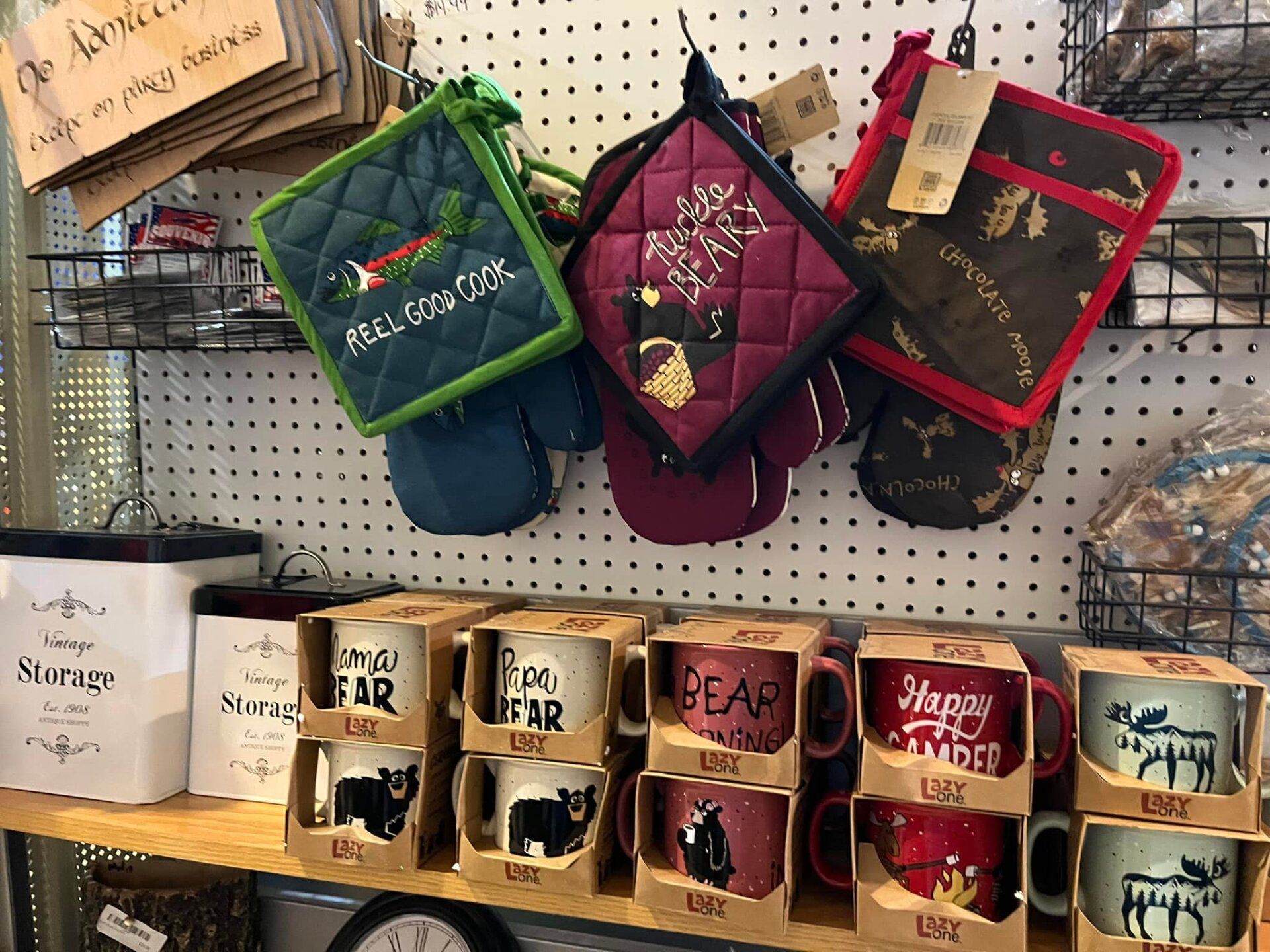 A shelf filled with lots of mugs and pot holders