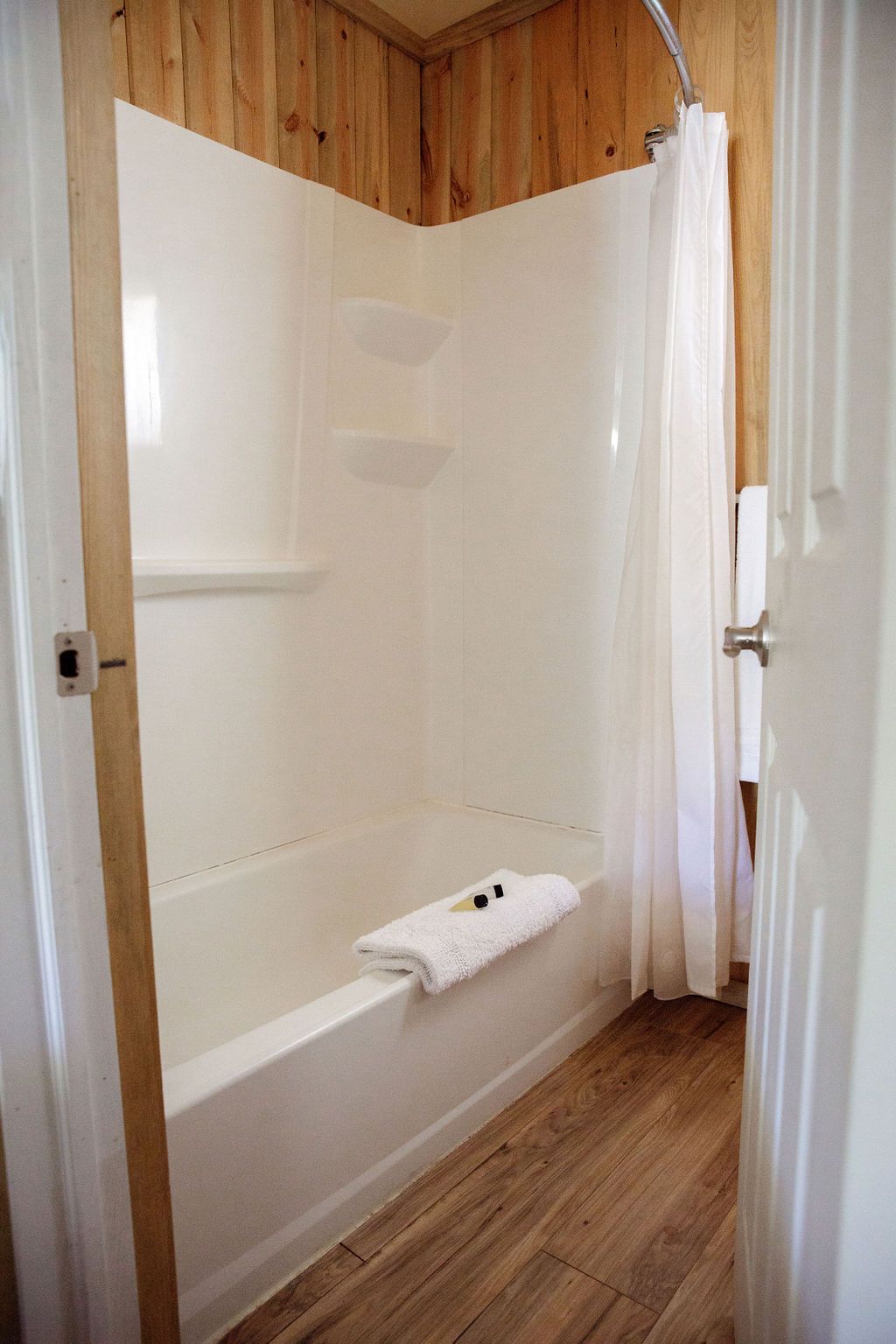 A bathroom with a bathtub and a shower.