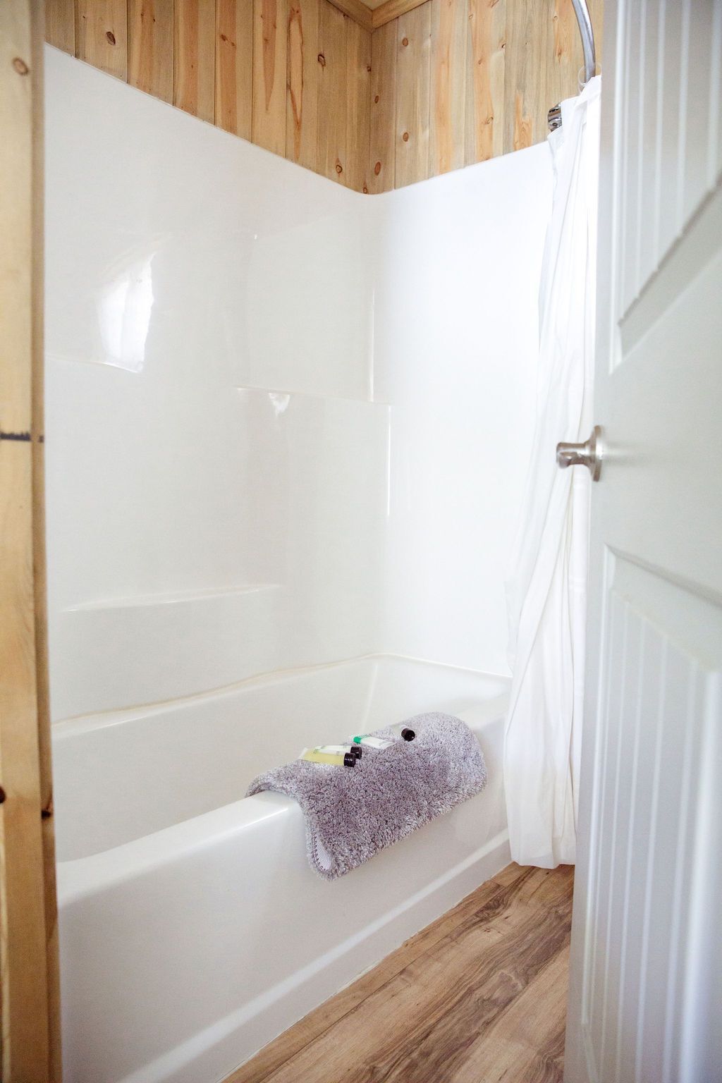 A bathroom with a bathtub and a shower.