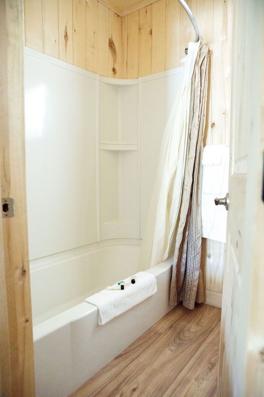 A bathroom with a bathtub and a shower curtain.