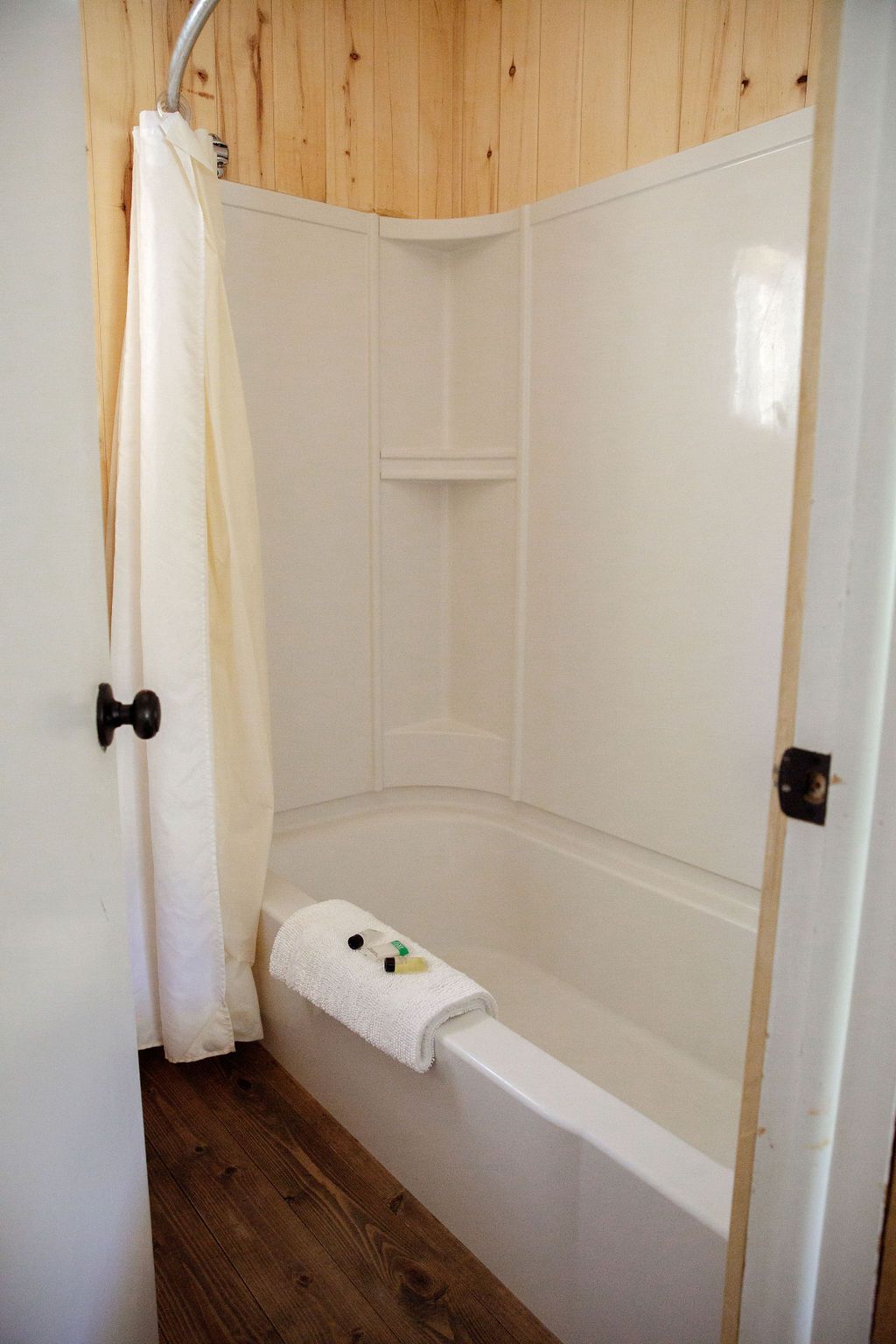 A bathroom with a bathtub and a shower.