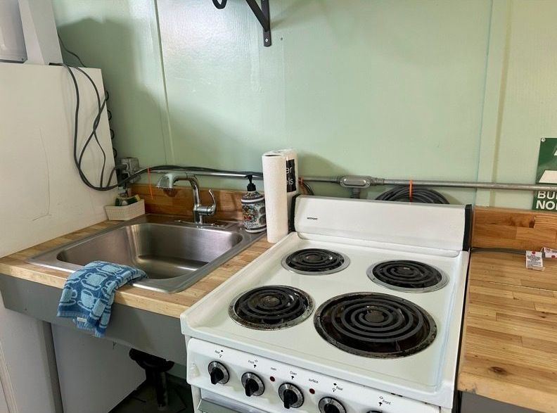 There is a stove and a sink in the kitchen.