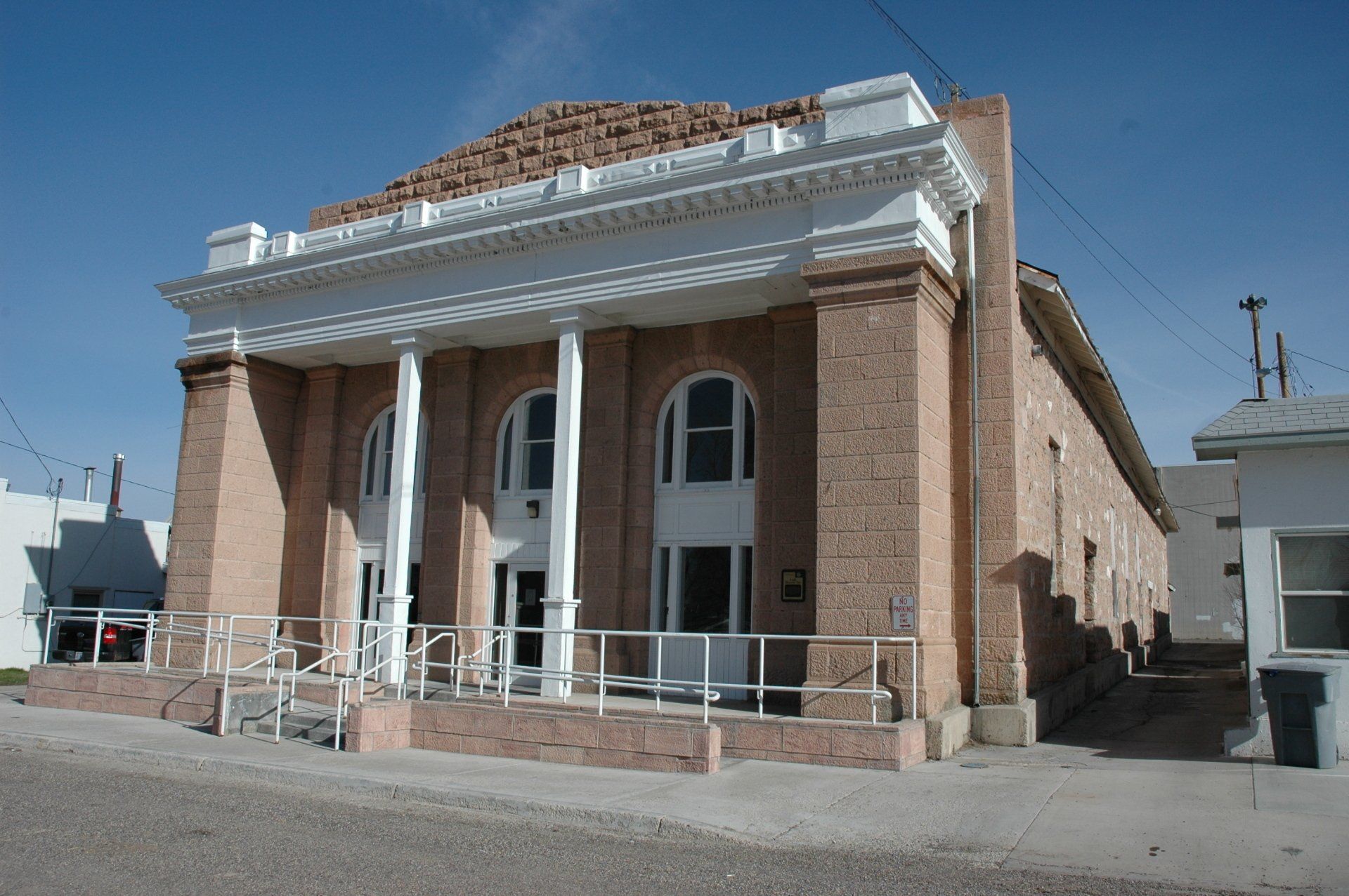 A large brick building with columns and arched windows