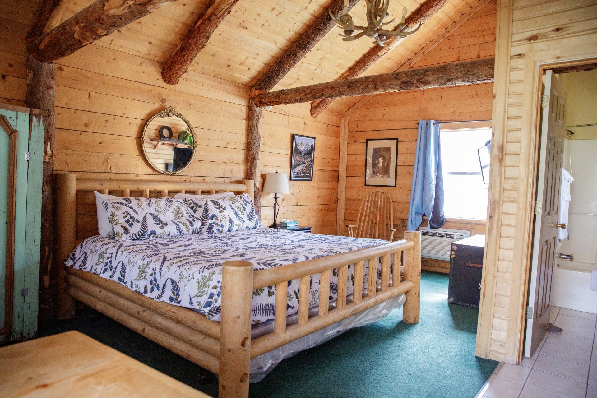 A bedroom in a log cabin with a king size bed