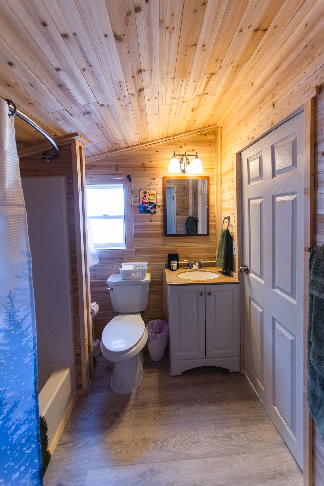 A bathroom with a toilet , sink , and shower.