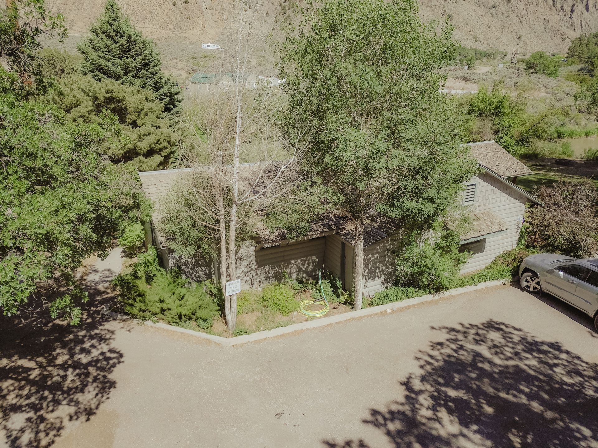 An aerial view of a house with a car parked in front of it.