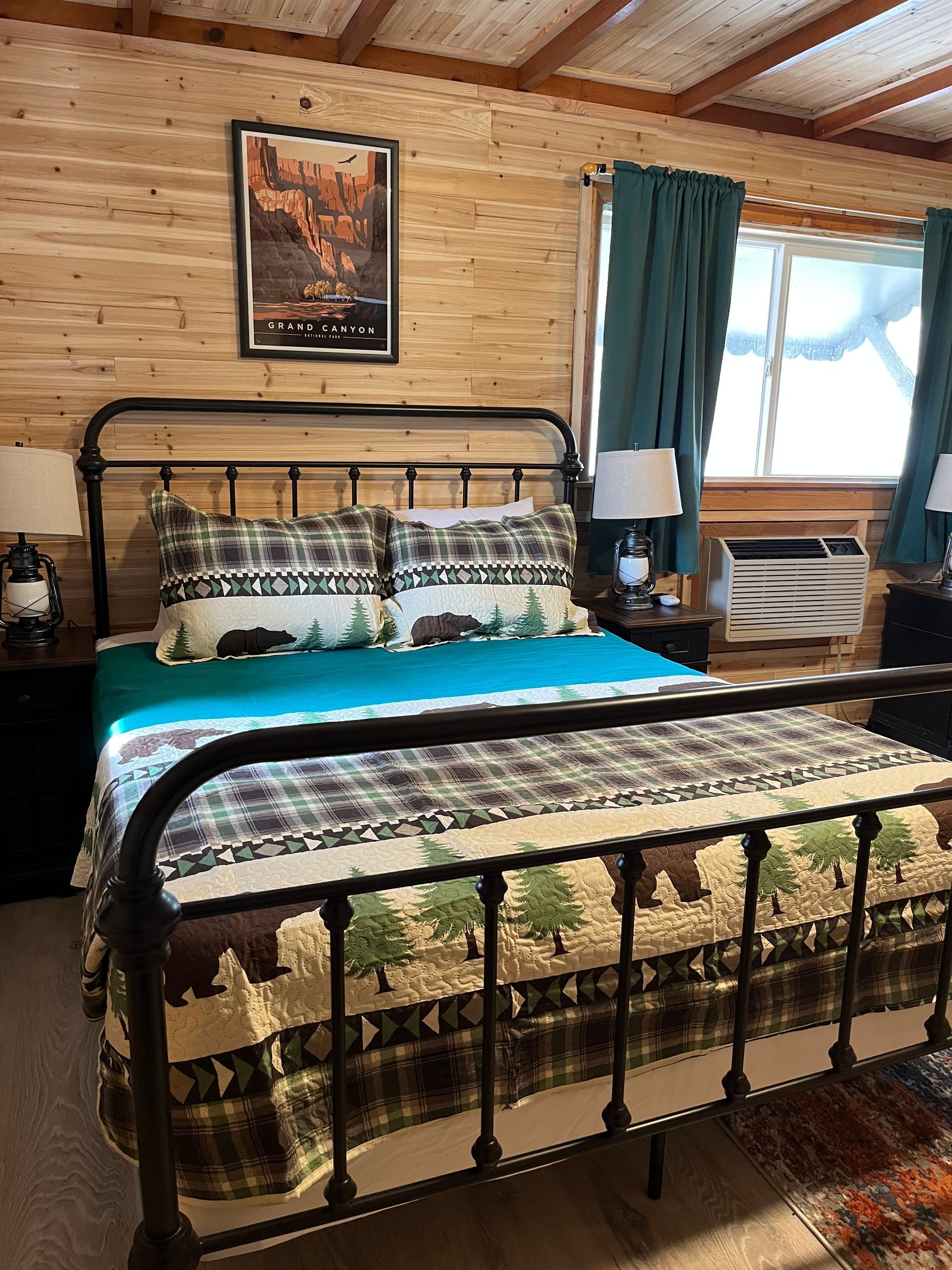 A bedroom with a bed , two nightstands and a window.