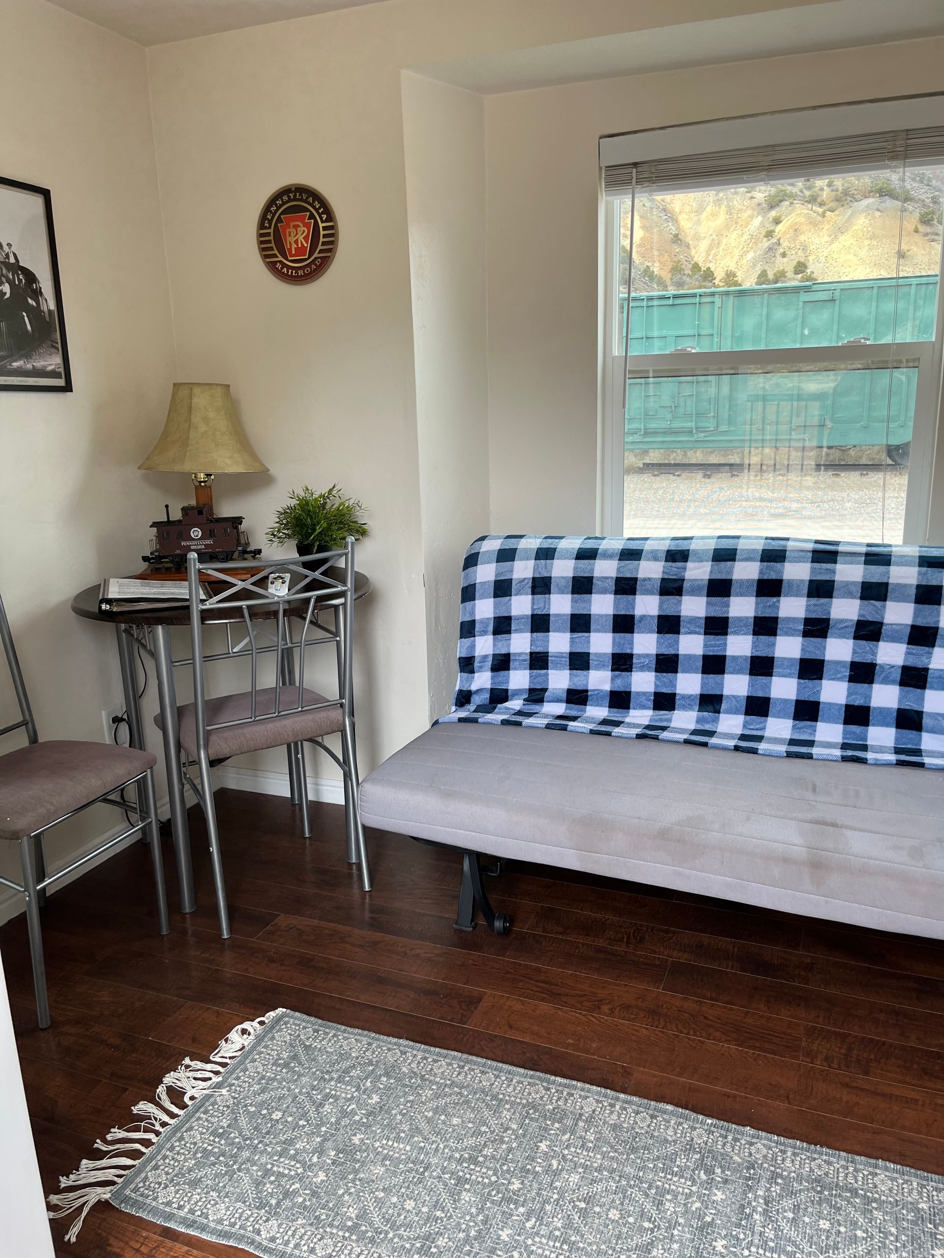 A living room with a couch , table and chairs