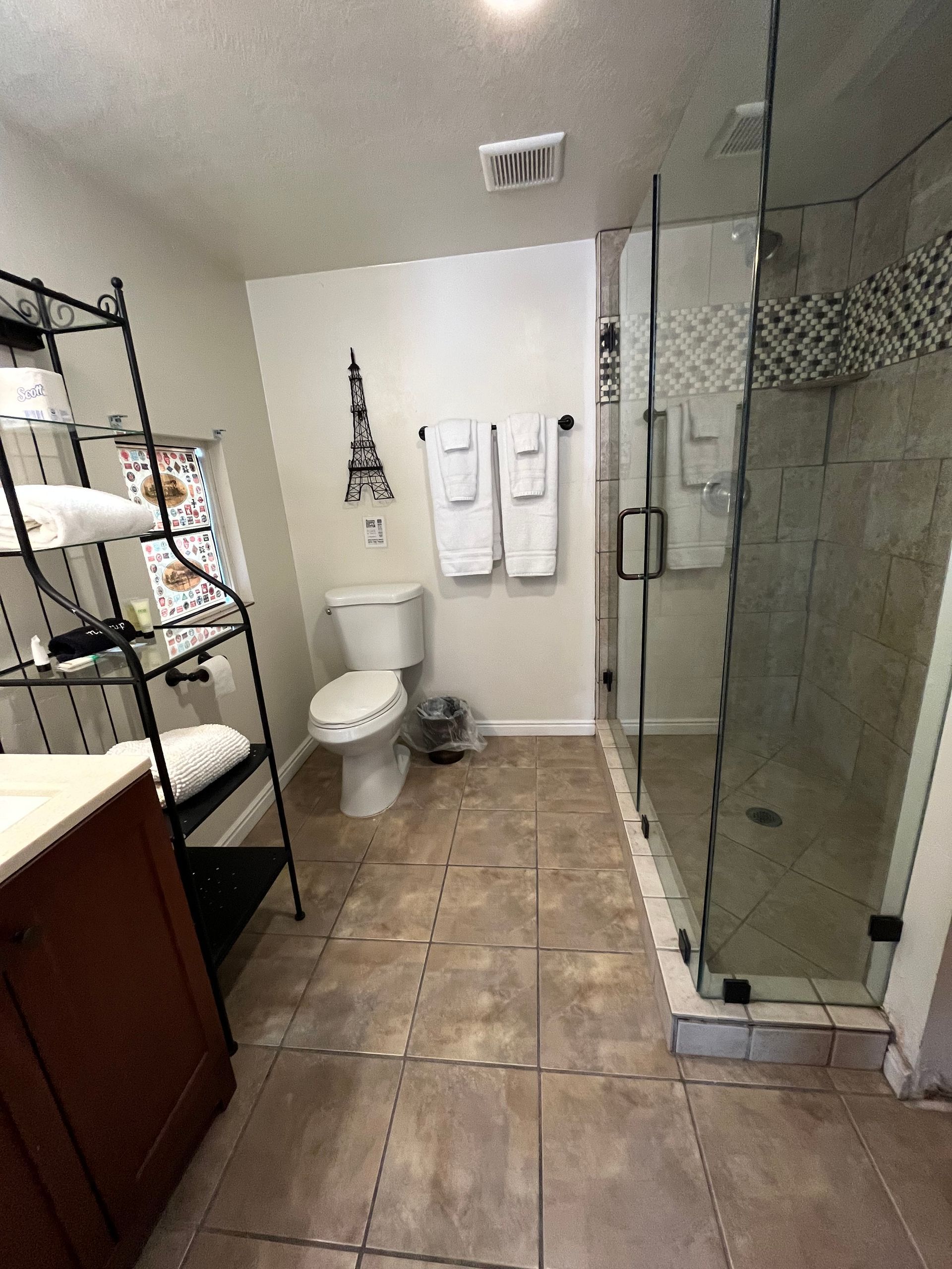 A bathroom with a toilet , sink , and shower.