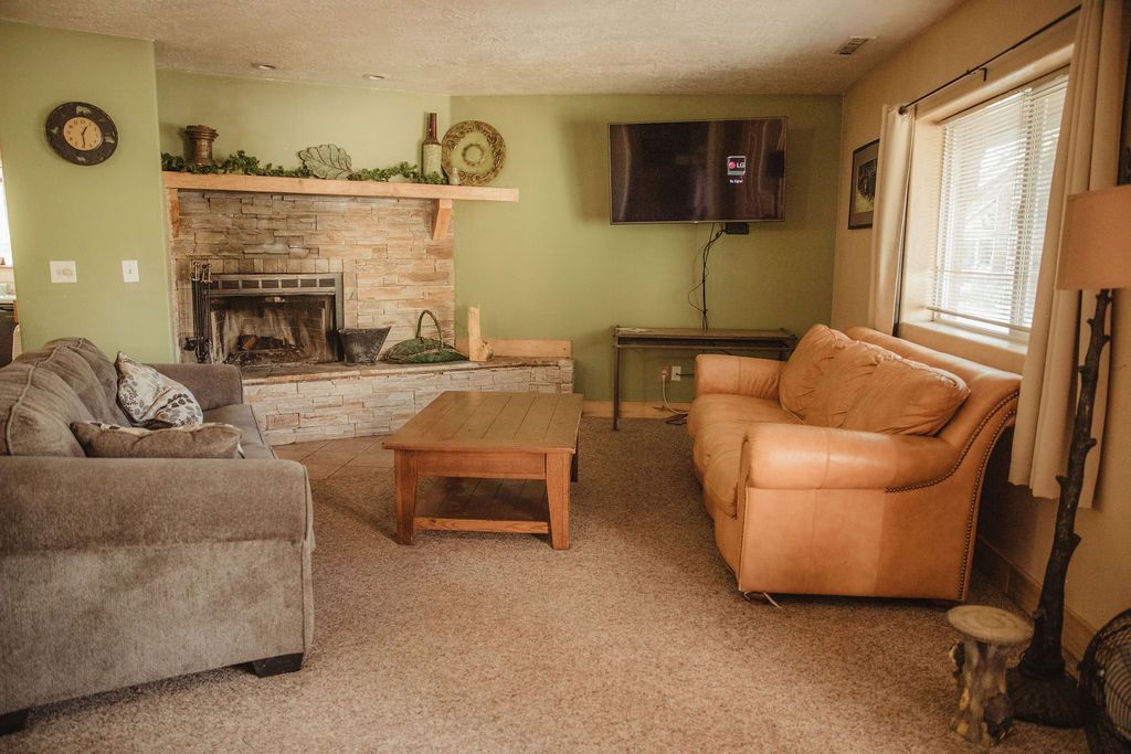 A living room filled with furniture and a fireplace.