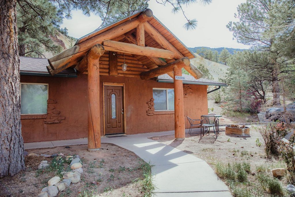 A log cabin with a concrete walkway leading to it