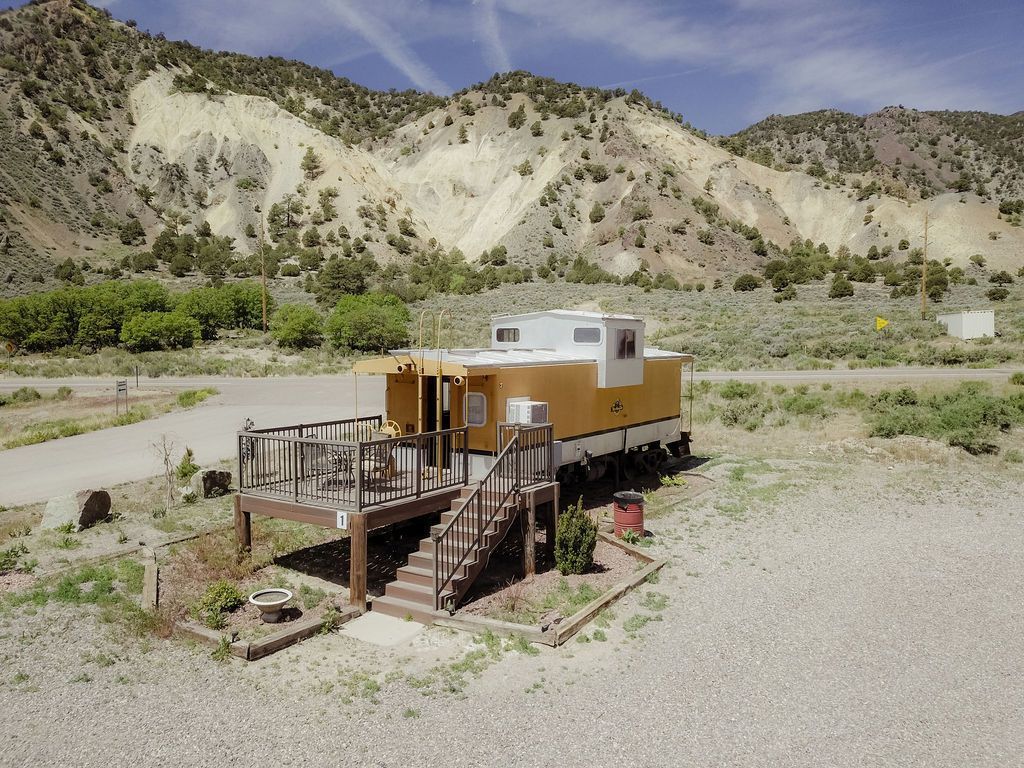 An aerial view of a train car with a deck and stairs.