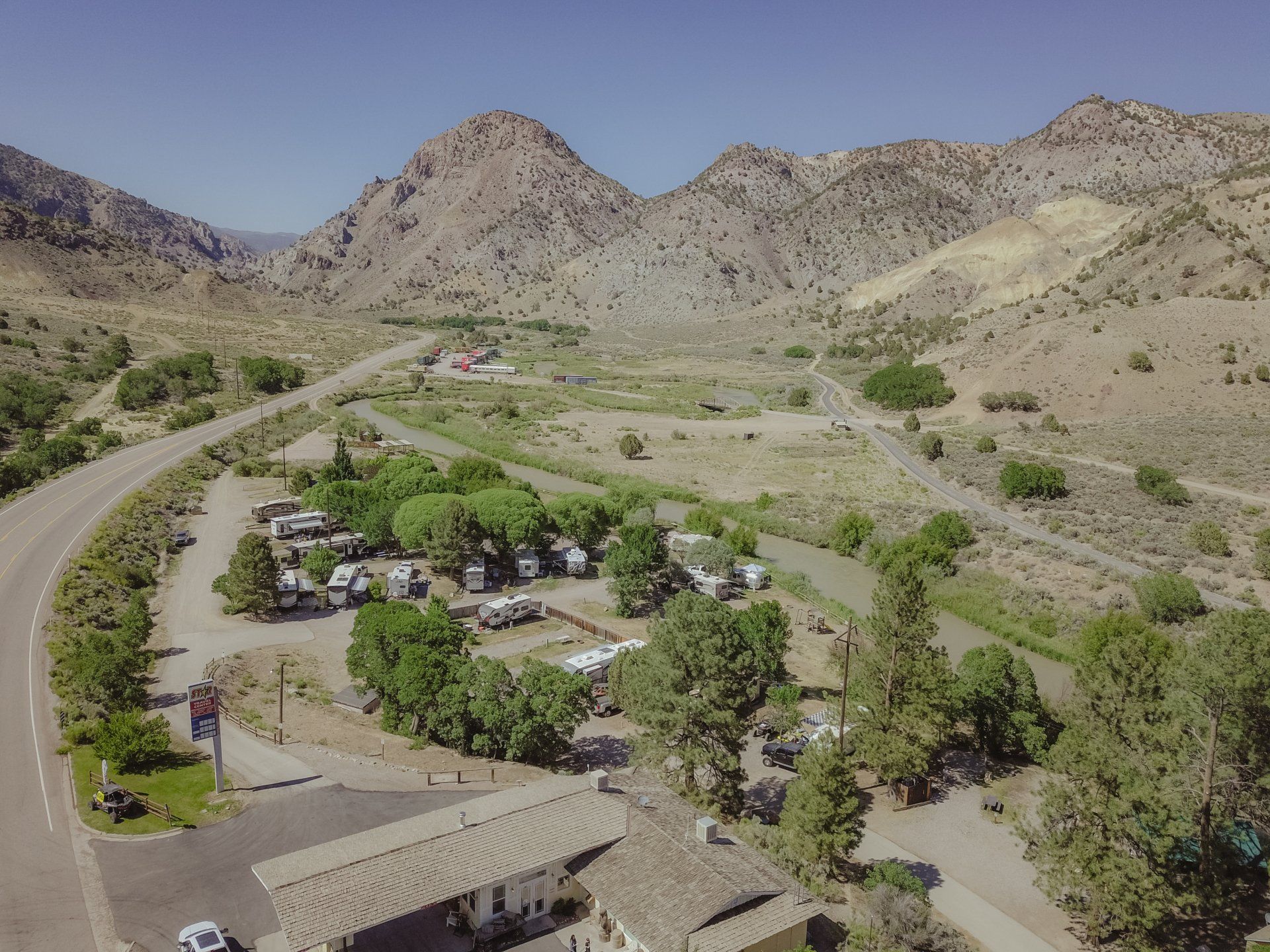 an aerial view of a campground with mountains in the background .